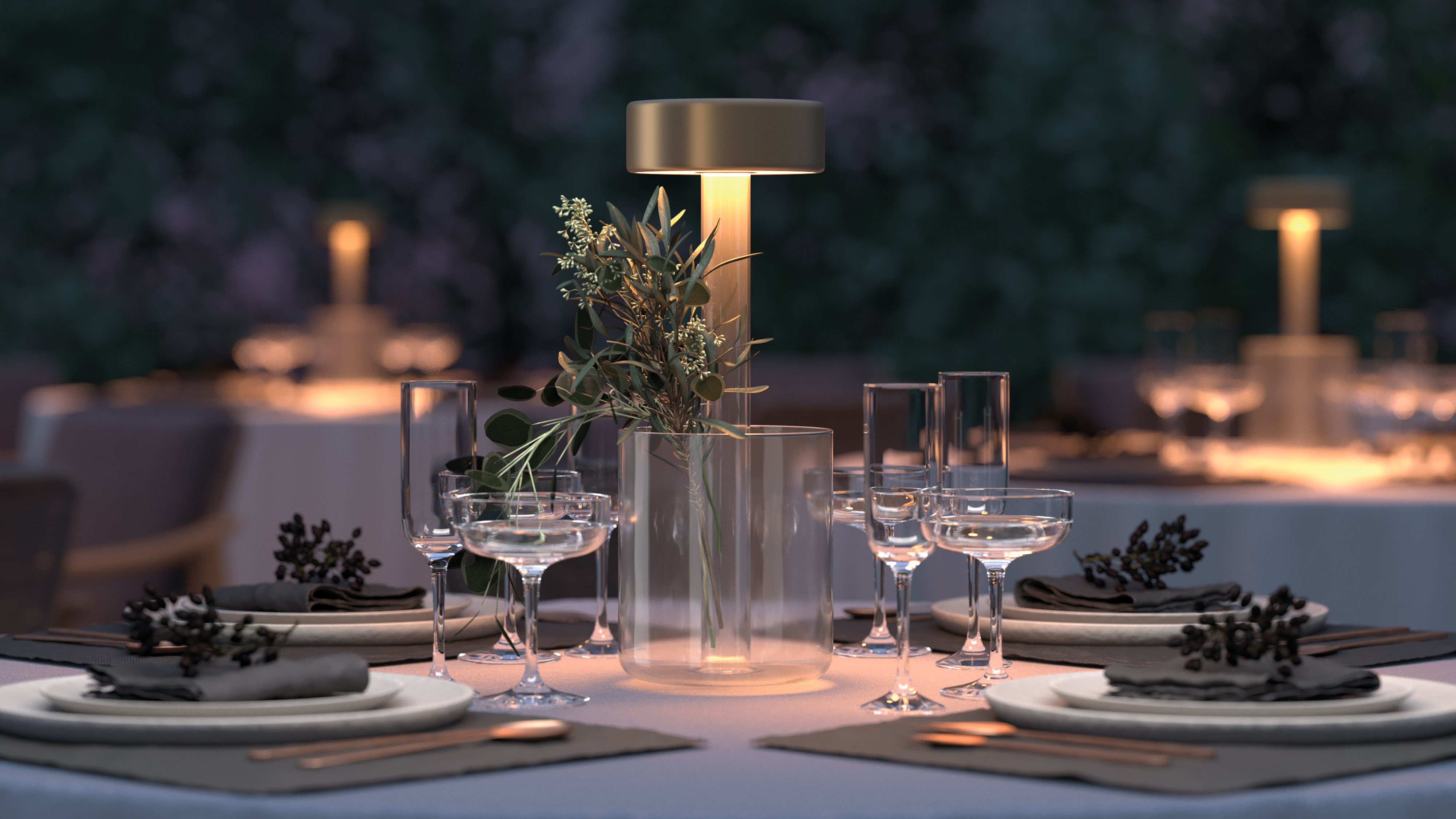 A gold-topped lamp with a clear vase holding greenery lights an outdoor dinner table